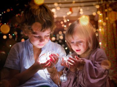 Children holding Christmas lights.
