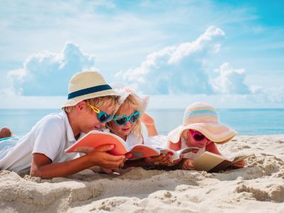 Children reading at the beach.