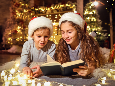 Children reading a Christmas book.