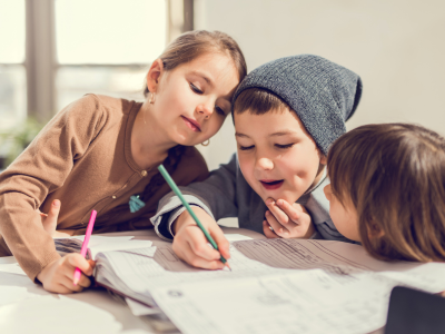 Children writing together.