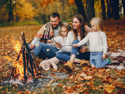 Family roasting marshmallows by the campfire.