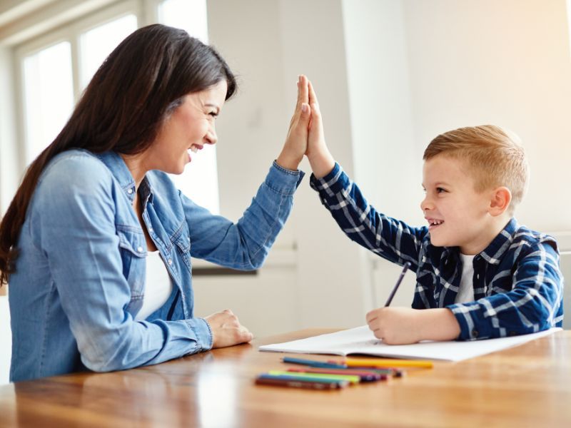 Child celebrating their writing with parent.