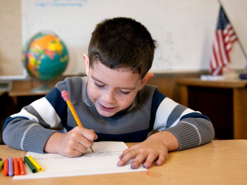 Child writing at a desk.