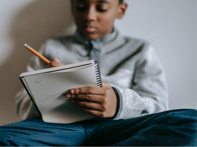 Child writing in notebook