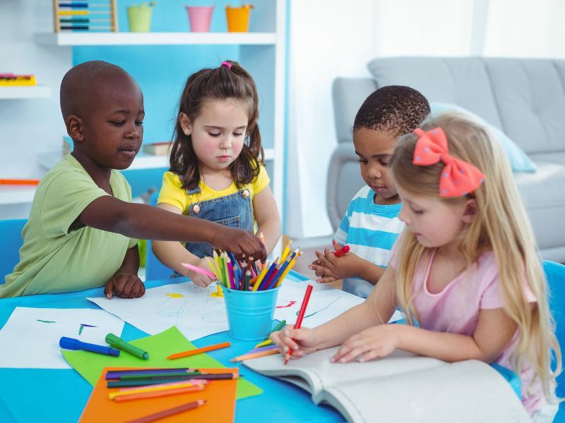 Four children, writing together.