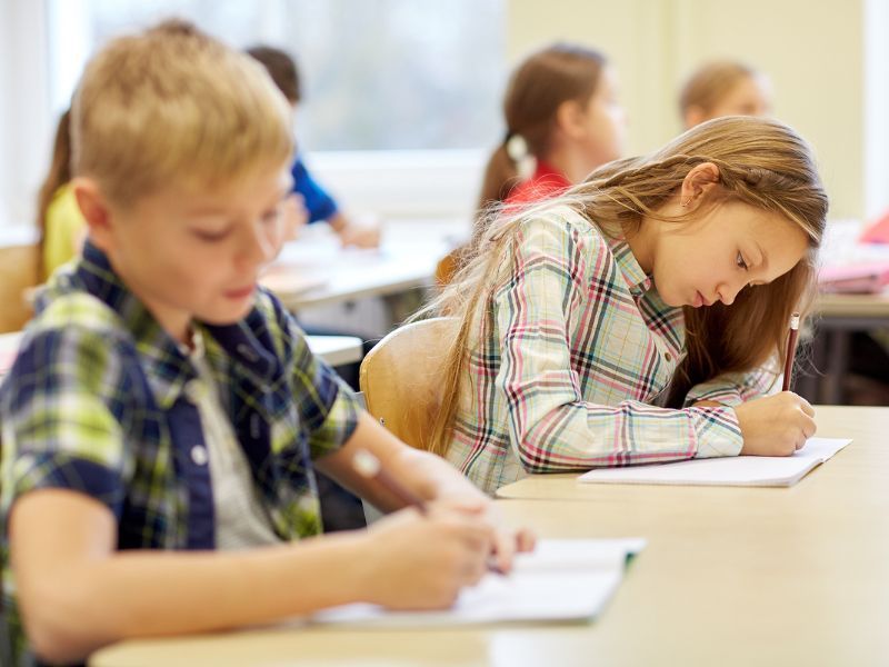 Children writing in class.