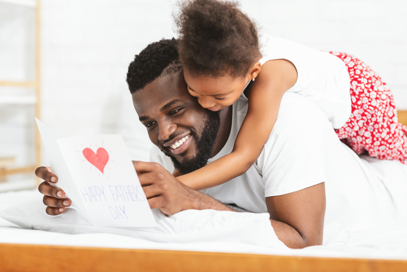 Father and child reading Father's Day card.