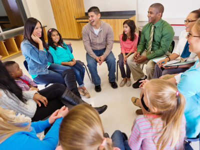 Parents and children sat in a circle, laughing.