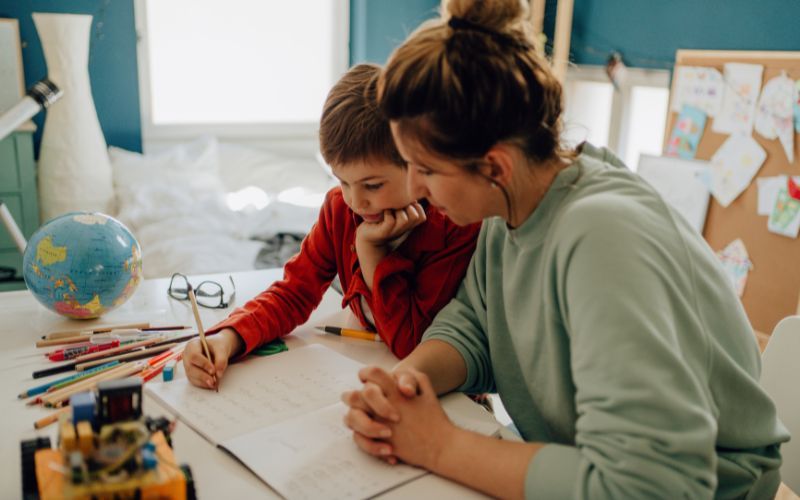 Parent and child, writing together.