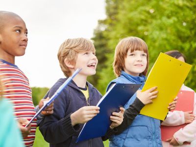 Group of children, holding books.