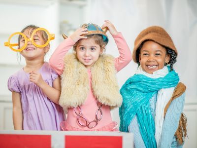 Three children playing dress up.
