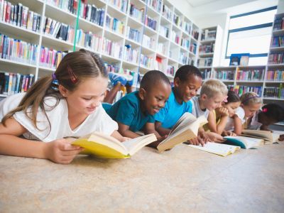 Children reading on the ground.