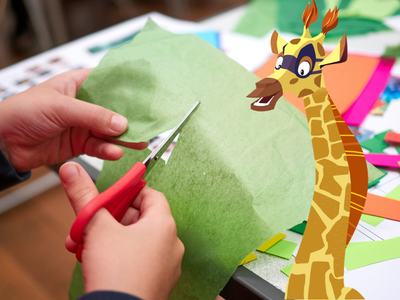 Sam the Giraffe looking at child cutting up colored paper.
