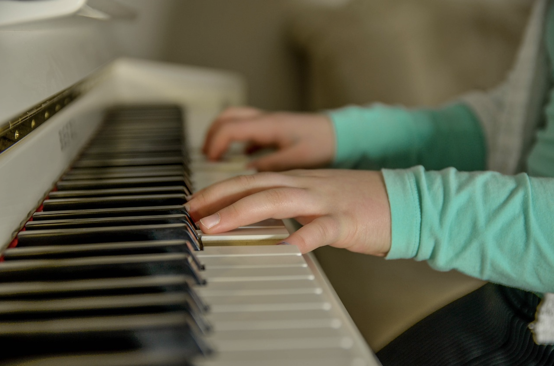 Hands on piano keyboard