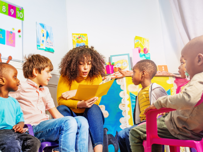 Teacher reading a story to students.