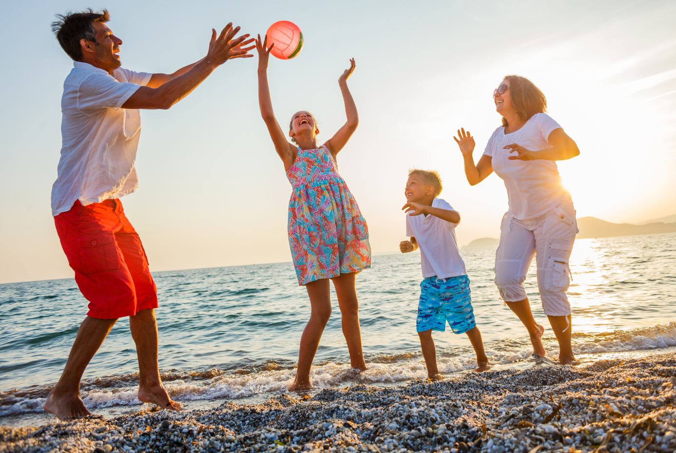 Family playing together at the beach.