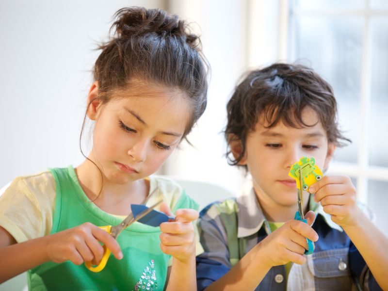 Two children doing arts and crafts.