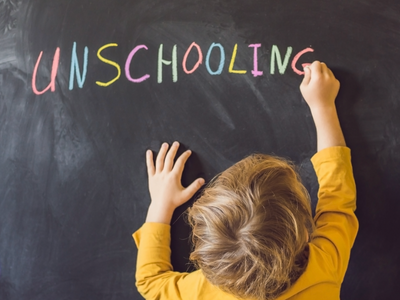 Child Writing Unschooling in chalk