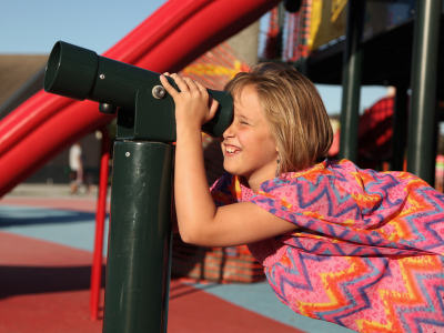 Child looking through a telescope.