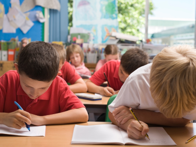 Children writing in class.