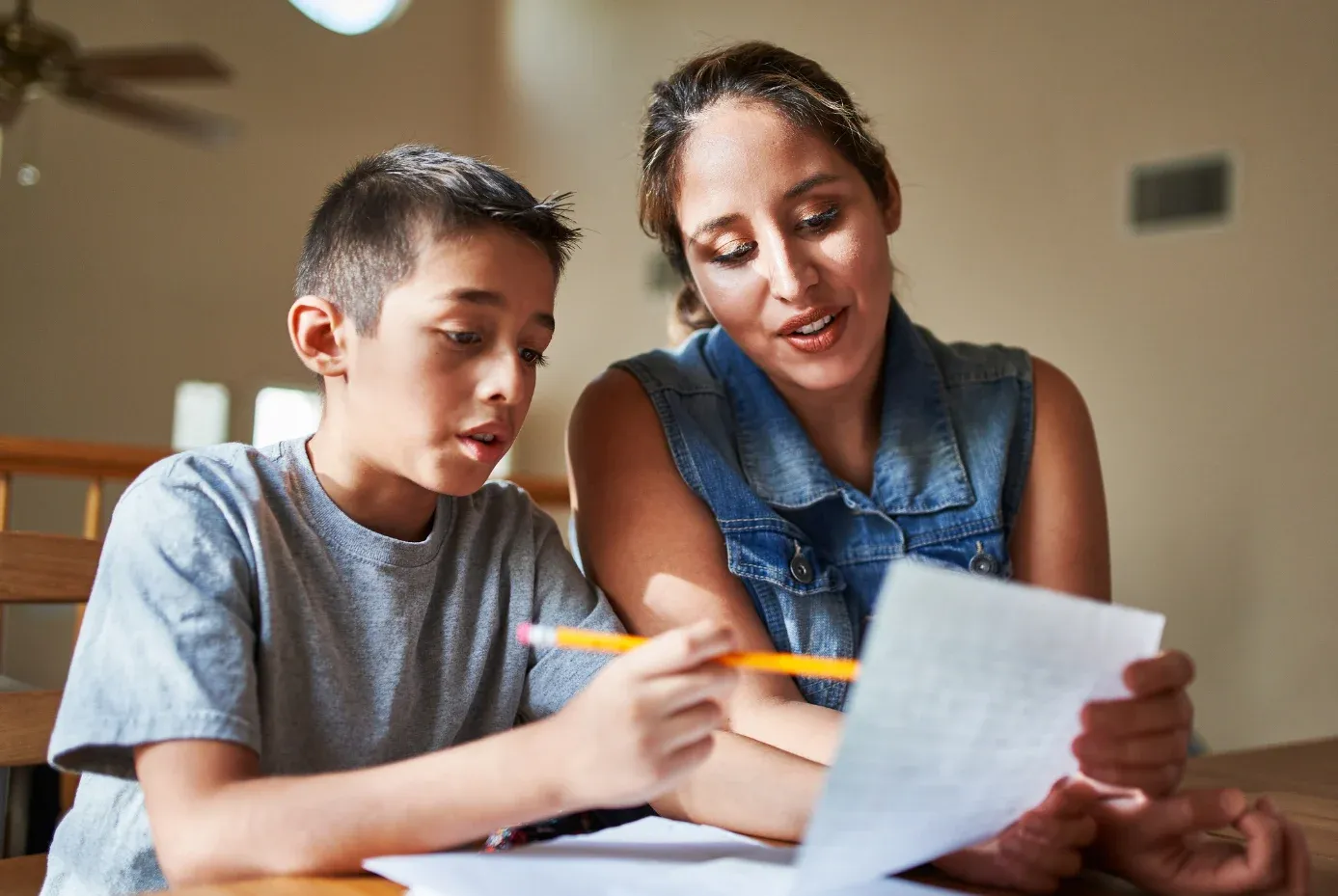 Mother and child, writing together.