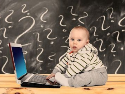 Baby sitting in front of a laptop