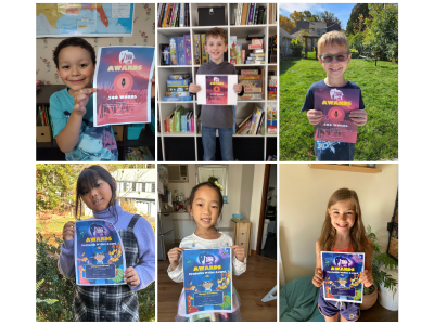 Children holding up Night Zookeeper awards.