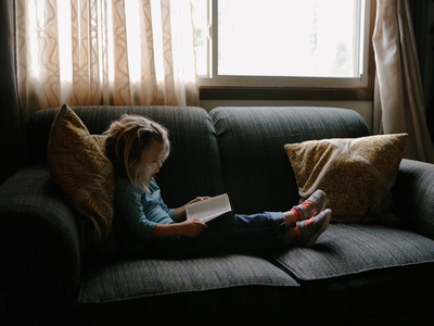Child reading on sofa