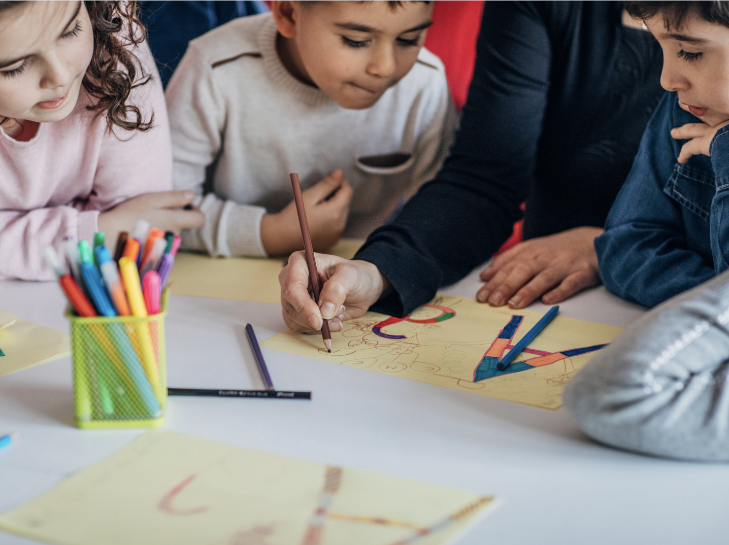 Children tracing the letters of the alphabet.