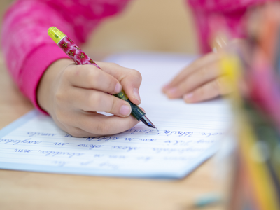 Hand holding pen and writing