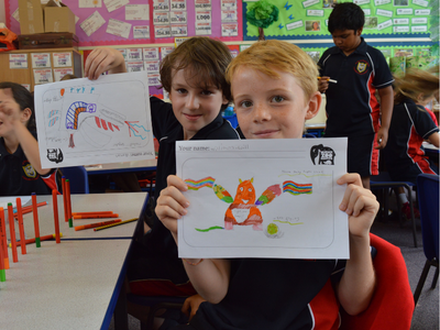 Children holding drawings