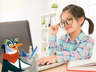 Girl sitting at desk typing on laptop with Professor Penguin.