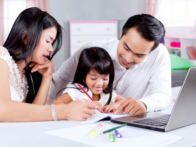 Parents helping child study at home