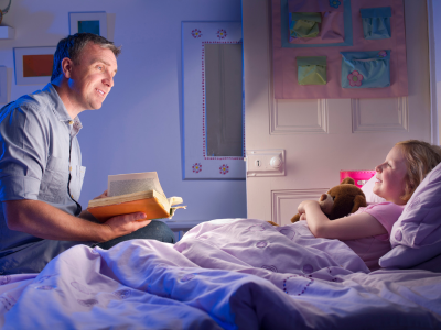 Parent reading bedtime story to child.