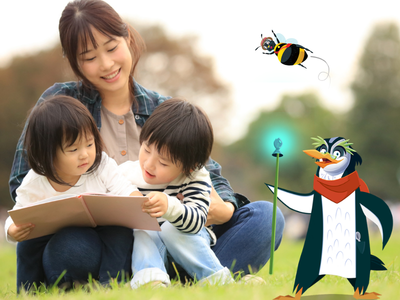Mom sitting on the grass with two children reading a book, with Professor Penguin and Bertie Bee. 