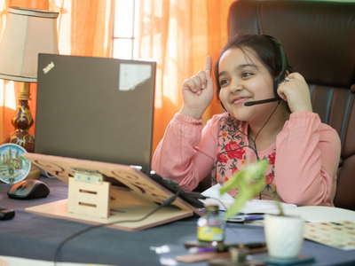 Girl with laptop on head phones smiling