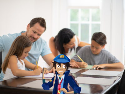 Family with 2 parents and 2 children sitting around a desk, with parents helping children write.