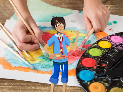 A child's hand painting on paper with an easel of paints. 