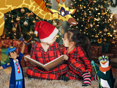 Children reading a book wearing santa hats by a Christmas tree with Night Zookeeper Will, Sam the Giraffe, and Professor Penguin.